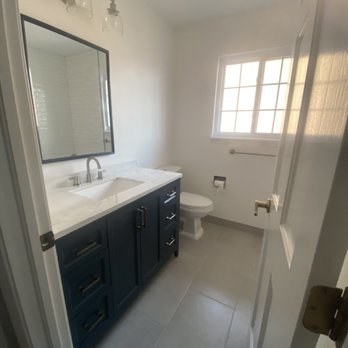 Bathroom remodel with navy vanity and marble countertop