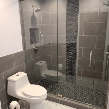 Walk-in shower remodel with dark tile surround