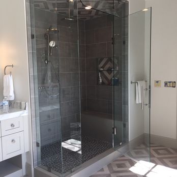 Corner shower remodel with marble-look tile